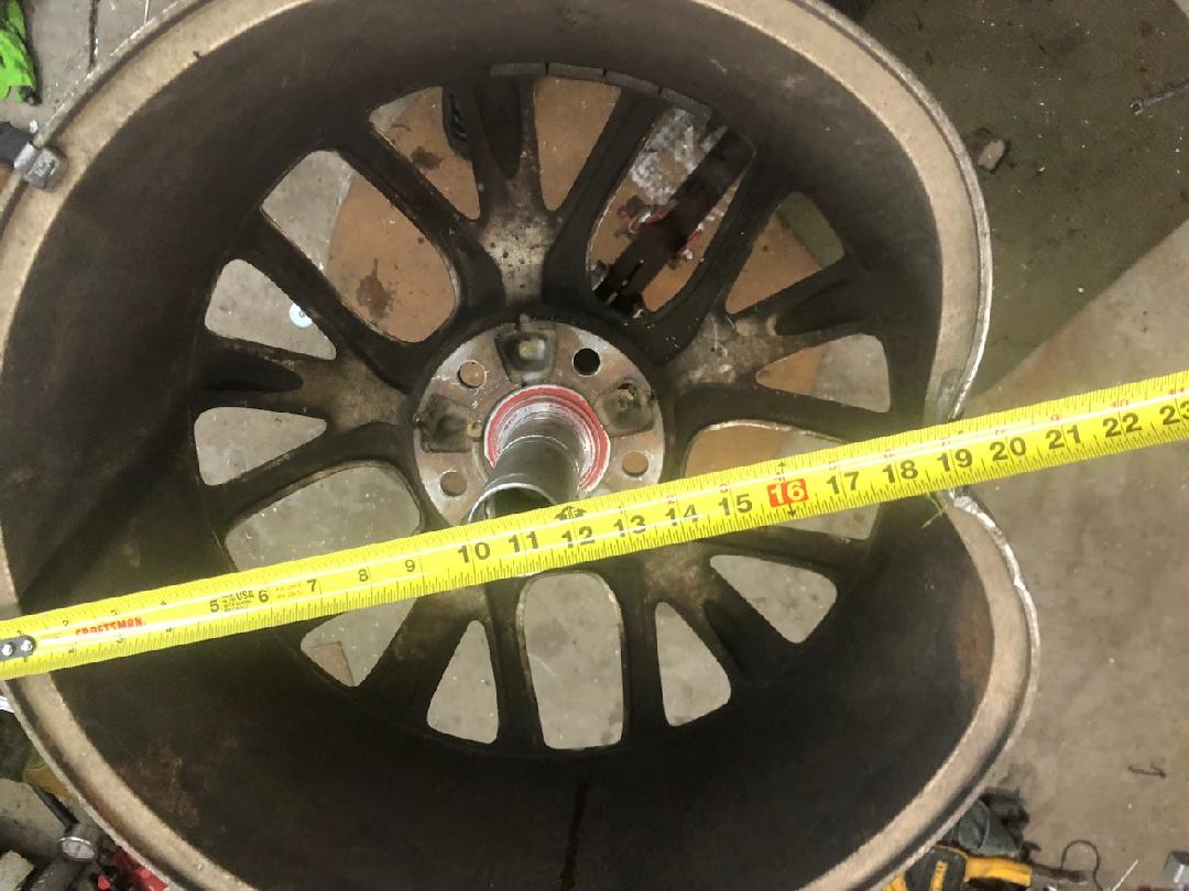 Black wheel with red brake calipers on a sedan