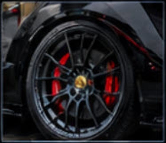 Black wheel with gold brake caliper