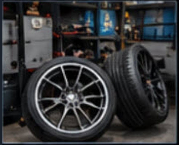 Restored wheels and tires staged in the shop, ready for pickup